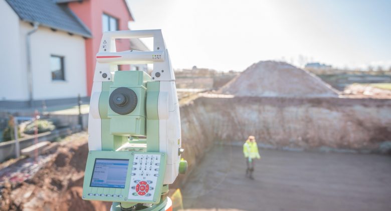 Total Station being used on construction site, conducting an as-built survey