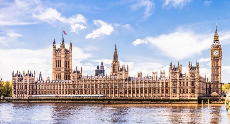 A view across the River Thames of Westminster Bridge leading towards the Palace of Westminster, home of the House of Commons, the House of Lords, and Big Ben.